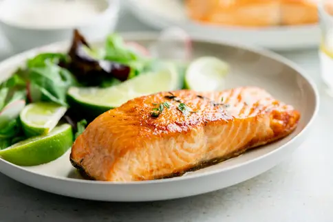 photo of salmon fillet with vegetable salad